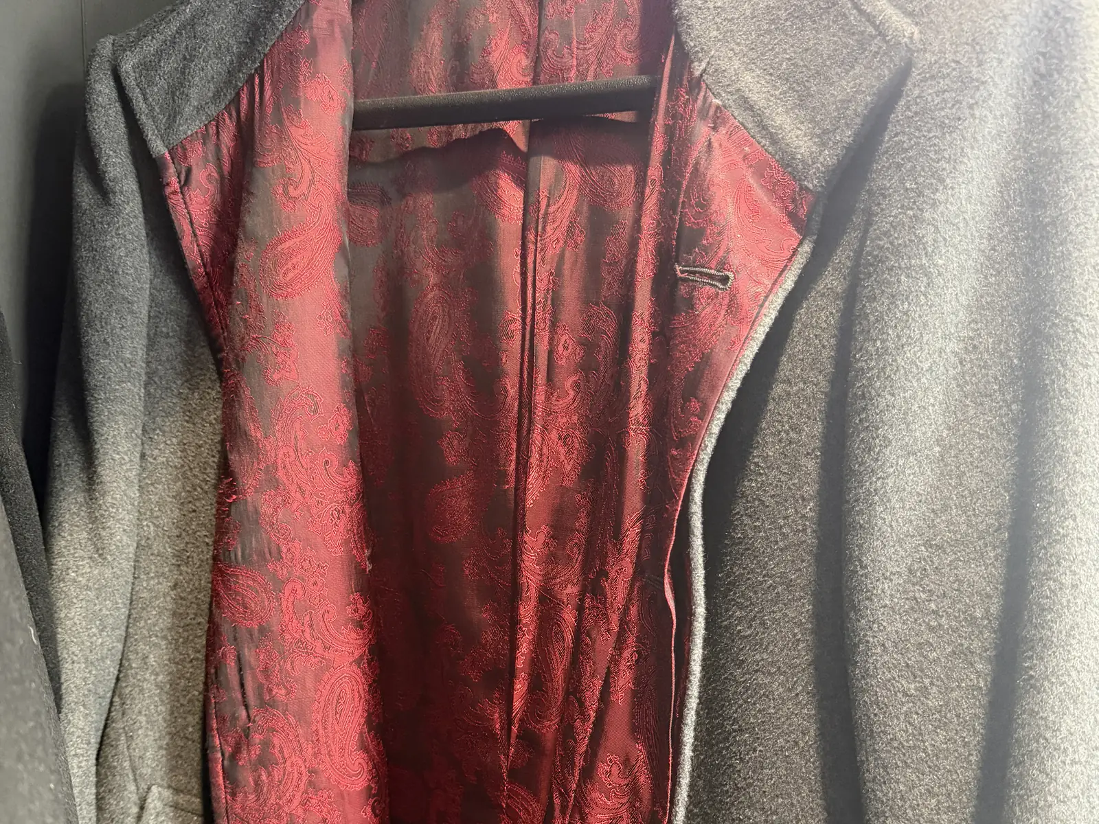 A charcoal wool top coat with a red paisley lining