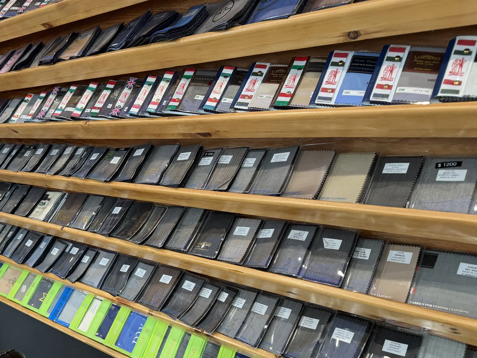 Inside Komal's Suits on Route 9: the wall of fabric books