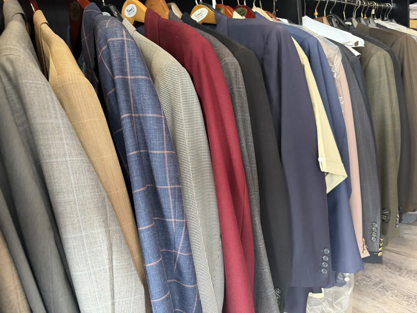 Custom jackets in windowpane, herringbone and houndstooth on the rack at Komal's Suits