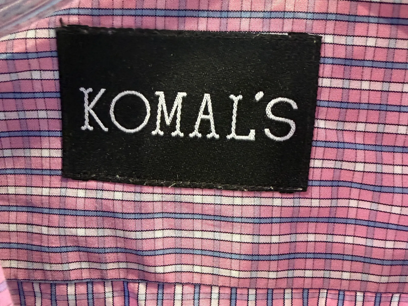 The Komal's label sewn into a pink check custom dress shirt